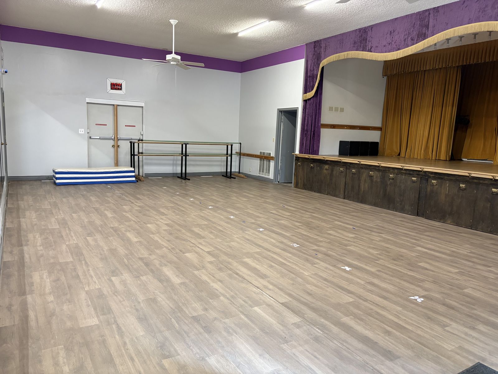 Another view of the Syracuse Dance Academy pilot space, with barres and a small stage